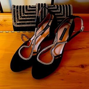 Black heeled shoes with rhinestone straps. Black and rhinestone evening bag.